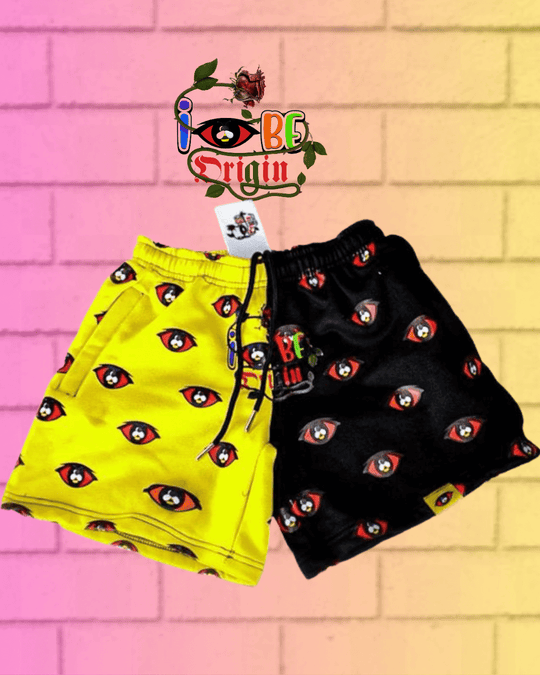 Fleece Bright Shorts in yellow and black with eye pattern, zipper pockets, and drawstring waist. 
